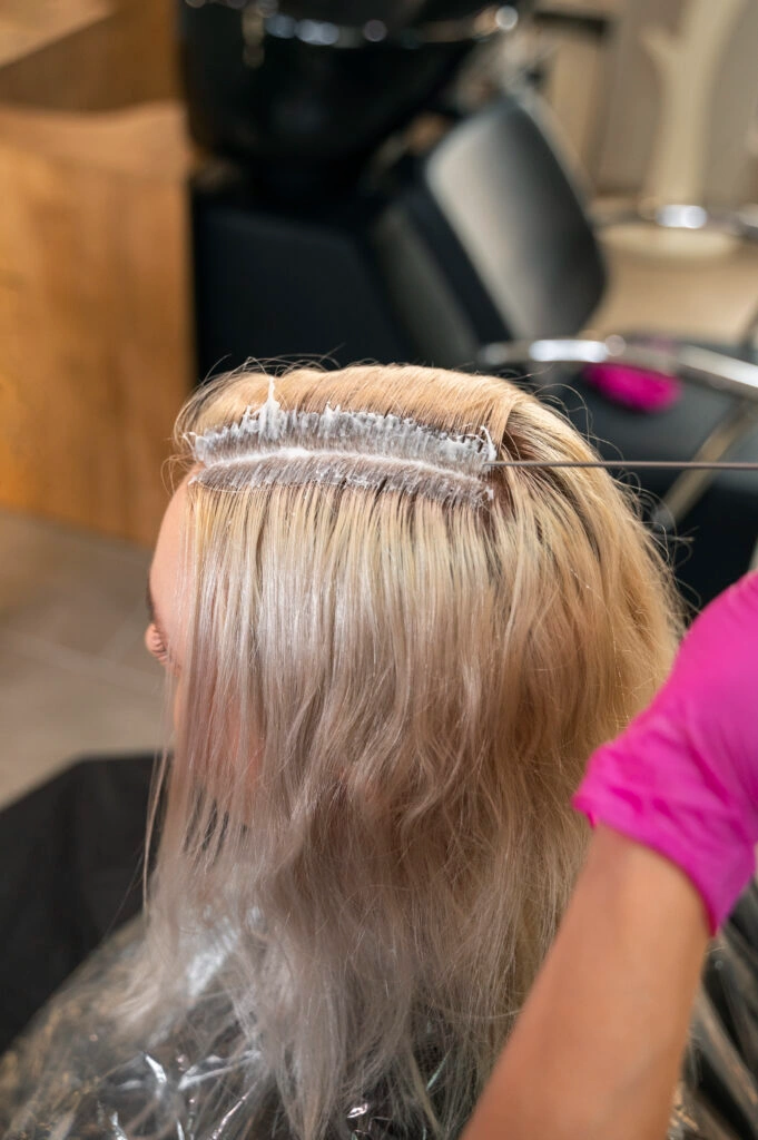 Woman getting hair treatment in salon